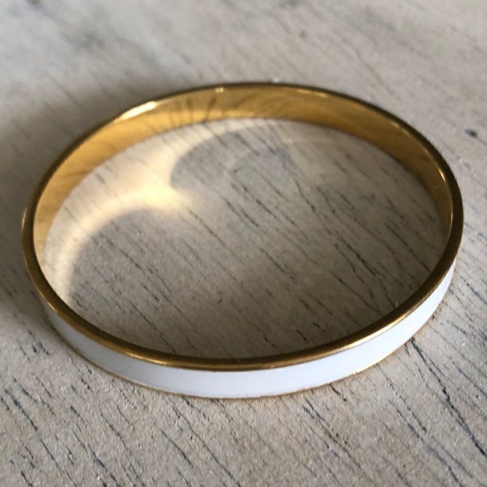 Monet White enamel and gold thin bangle bracelet.